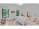Bright bedroom featuring light hardwood floors, two windows, and a plush rug at 401 Brinkman Ct, Raleigh, NC 27614