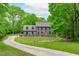Stunning two-story home with a long driveway, gray facade, meticulous landscaping, and a welcoming front yard at 401 Brinkman Ct, Raleigh, NC 27614