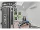 Bright home gym featuring a full range of exercise equipment, skylight, and french doors to backyard at 401 Brinkman Ct, Raleigh, NC 27614