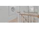 Bright hallway showcasing wood-trimmed banister, white walls, and wood-look flooring at 401 Brinkman Ct, Raleigh, NC 27614