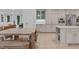 Bright kitchen featuring a large wooden table, custom cabinets, and an island with white marble countertop at 401 Brinkman Ct, Raleigh, NC 27614