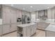 Beautiful kitchen featuring gray cabinets, stainless steel appliances, and a center island with marble countertops at 401 Brinkman Ct, Raleigh, NC 27614