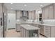 Well-lit kitchen featuring custom gray cabinetry, stainless appliances, subway tile backsplash and large island at 401 Brinkman Ct, Raleigh, NC 27614
