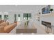Open-concept living area with a modern fireplace, leading to a dining area and outdoor views at 401 Brinkman Ct, Raleigh, NC 27614