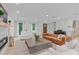 Elegant living room with a fireplace, hardwood floors, and an open layout to the kitchen at 401 Brinkman Ct, Raleigh, NC 27614