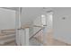 A staircase with hardwood floors and white risers is adjacent to a door and thermostat at 401 Brinkman Ct, Raleigh, NC 27614
