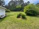 View of the side and back yard featuring a well maintained lawn and landscaping at 407 N Cheatham St, Franklinton, NC 27525