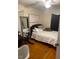 Cozy bedroom featuring hardwood floors at 407 N Cheatham St, Franklinton, NC 27525