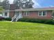 Charming brick ranch-style home with well-maintained lawn and inviting entrance at 407 N Cheatham St, Franklinton, NC 27525