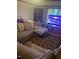 Living room space featuring an area rug, sofa, and television at 407 N Cheatham St, Franklinton, NC 27525