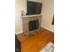 Living room with stone fireplace and hardwood floors at 407 N Cheatham St, Franklinton, NC 27525