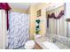 Well-lit bathroom with a marble countertop, decorative mirror, and shower-tub combination at 4125 Palafox Ct, Raleigh, NC 27604