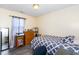 Well-lit bedroom with a desk, dresser, and a comfortable bed at 4125 Palafox Ct, Raleigh, NC 27604