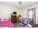 Cozy bedroom with twin beds, dresser, and warm natural lighting at 4125 Palafox Ct, Raleigh, NC 27604