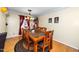 Dining room features hardwood floors, traditional chandelier and dining table with seating for six at 4125 Palafox Ct, Raleigh, NC 27604