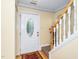 Inviting entryway featuring a decorative front door, hardwood floors and staircase with white painted wood risers at 4125 Palafox Ct, Raleigh, NC 27604