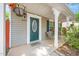 Inviting front porch with a green front door and lovely seating area at 4125 Palafox Ct, Raleigh, NC 27604