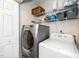 Efficient laundry room with modern washer and dryer units and storage shelving at 4125 Palafox Ct, Raleigh, NC 27604