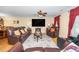 Spacious living room features plush leather seating and a large flat-screen television at 4125 Palafox Ct, Raleigh, NC 27604