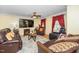 Comfortable living room featuring hardwood floors, a ceiling fan, and a cozy fireplace at 4125 Palafox Ct, Raleigh, NC 27604