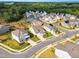 An aerial view of a residential area showcasing well-maintained homes, manicured lawns, and tree-lined streets in a planned community at 4333 Benton Mill Dr, Fuquay Varina, NC 27526