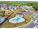 Aerial view of the community pool, clubhouse, and surrounding neighborhood, showcasing well-maintained landscaping at 4333 Benton Mill Dr, Fuquay Varina, NC 27526