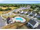 An aerial view of a community pool, clubhouse, and surrounding homes with a picturesque park and green space at 4333 Benton Mill Dr, Fuquay Varina, NC 27526