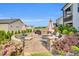 Beautiful backyard stone patio with outdoor seating, fire pit, grill, landscaping, and a built-in stone surround at 4333 Benton Mill Dr, Fuquay Varina, NC 27526