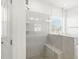 This bright bathroom boasts a glass enclosed shower, gray tiling, and a built-in bench at 4333 Benton Mill Dr, Fuquay Varina, NC 27526