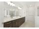 Bathroom features dual sinks, granite countertops, a large mirror, and glass enclosed shower at 4333 Benton Mill Dr, Fuquay Varina, NC 27526