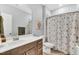 Bathroom with a shower and tub combo with a decorative shower curtain and single sink vanity at 4333 Benton Mill Dr, Fuquay Varina, NC 27526