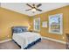 Bedroom featuring warm yellow walls, natural light, and a ceiling fan at 4333 Benton Mill Dr, Fuquay Varina, NC 27526