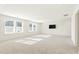 Bright bonus room with multiple windows, television, and carpet at 4333 Benton Mill Dr, Fuquay Varina, NC 27526