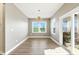 Formal dining room features a modern chandelier, large window, and sliding glass doors at 4333 Benton Mill Dr, Fuquay Varina, NC 27526