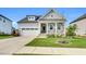 Charming home featuring a welcoming front porch and a well-maintained lawn with pretty landscaping at 4333 Benton Mill Dr, Fuquay Varina, NC 27526