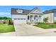 Charming home featuring a welcoming front porch and a well-maintained lawn with pretty landscaping at 4333 Benton Mill Dr, Fuquay Varina, NC 27526