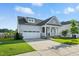 Charming home with a covered front porch, two-car garage, manicured lawn, and beautiful landscaping at 4333 Benton Mill Dr, Fuquay Varina, NC 27526