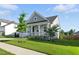 Charming home with a covered front porch, two-car garage, manicured lawn, and beautiful landscaping at 4333 Benton Mill Dr, Fuquay Varina, NC 27526