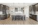 Spacious kitchen with stainless appliances, gray cabinets, a large island, and modern pendant lighting at 4333 Benton Mill Dr, Fuquay Varina, NC 27526