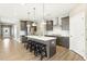 Spacious kitchen with stainless appliances, gray cabinets, a large island, and modern pendant lighting at 4333 Benton Mill Dr, Fuquay Varina, NC 27526