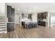 Spacious kitchen with stainless appliances, gray cabinets, a large island with seating, and pendant lighting at 4333 Benton Mill Dr, Fuquay Varina, NC 27526