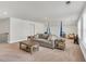 Spacious living room area with plush carpeting, neutral tones, and playroom area in the background at 4333 Benton Mill Dr, Fuquay Varina, NC 27526