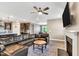 Living room with a fireplace, large TV, lots of natural light, and comfortable leather seating at 4333 Benton Mill Dr, Fuquay Varina, NC 27526