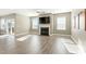 Spacious living room featuring a fireplace, large windows, ceiling fan and wood flooring at 4333 Benton Mill Dr, Fuquay Varina, NC 27526