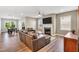 Living room with a fireplace, large TV, lots of natural light, and comfortable leather seating at 4333 Benton Mill Dr, Fuquay Varina, NC 27526