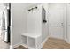 Mudroom features built-in bench, hooks, shelving, and a white interior door at 4333 Benton Mill Dr, Fuquay Varina, NC 27526