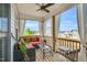 Relaxing covered patio features comfortable seating, ceiling fan, and natural light at 4333 Benton Mill Dr, Fuquay Varina, NC 27526