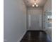 Bright entryway with hardwood floors, a white front door, and decorative chandelier at 44 Cooper Branch Ct, Fuquay Varina, NC 27526