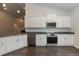 Well-equipped kitchen with granite countertops, stainless steel appliances and white cabinets at 44 Cooper Branch Ct, Fuquay Varina, NC 27526