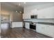Modern kitchen features stainless steel appliances, granite countertops, and white cabinetry at 44 Cooper Branch Ct, Fuquay Varina, NC 27526